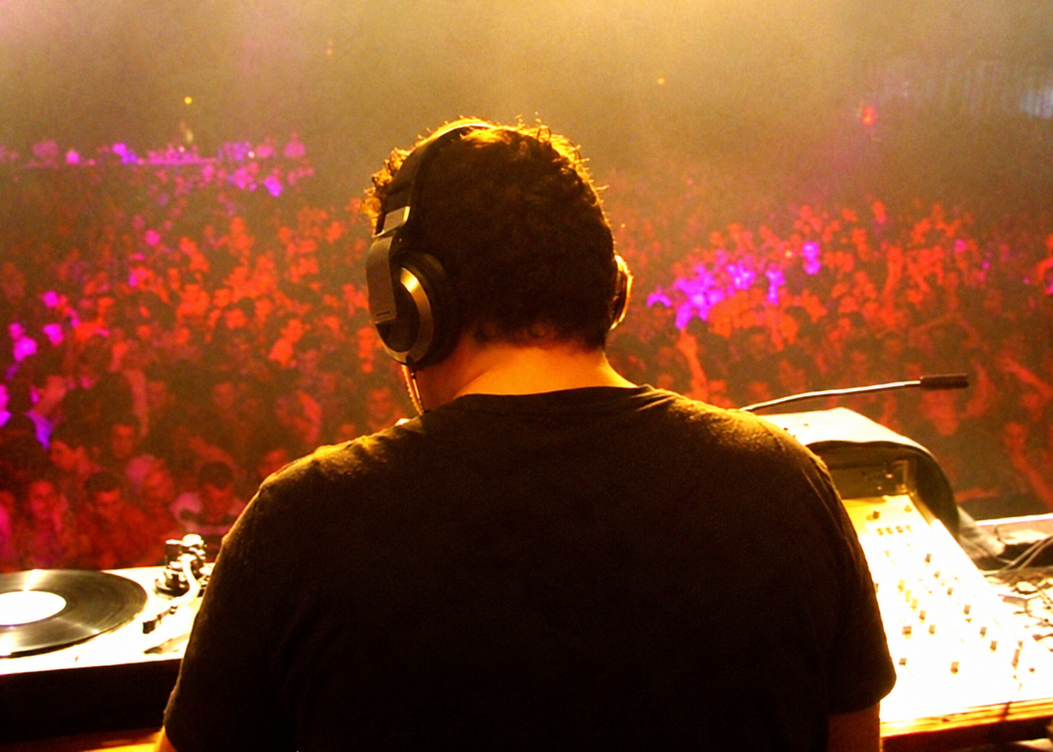 Luke Driver mixing at the decks in front of a club crowd